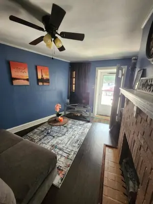 a living room with a couch and a ceiling fan at The Spot in Stonehurst