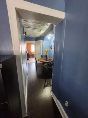 a hallway with a dining room table and blue walls at The Spot in Stonehurst