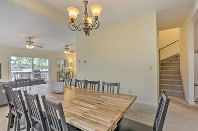 a dining room with a wooden table and chairs at Spacious Lakefront House With a Private Dock in Hopatcong