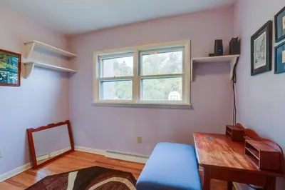 a living room with a table and a window at Quaint Horseheads Home about 9 Mi to Elmira College in Horseheads
