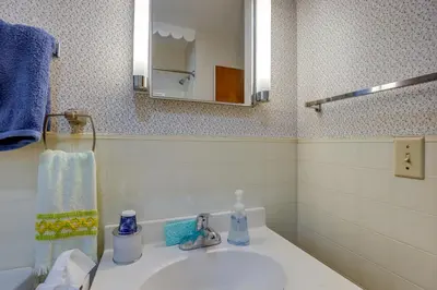 a bathroom with a sink and a mirror at Quaint Horseheads Home about 9 Mi to Elmira College in Horseheads