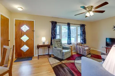 a living room with a ceiling fan and a table and chairs at Quaint Horseheads Home about 9 Mi to Elmira College in Horseheads
