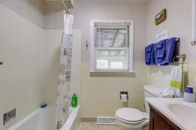 a bathroom with a toilet and a tub and a sink at Quaint Horseheads Home about 9 Mi to Elmira College in Horseheads