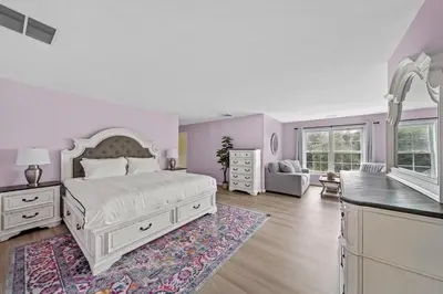 a white bedroom with a bed and a kitchen at 13-Acre Private Estate, Private Lake, Private Golf Range, Private Forest & Hiking Trails in Ross Corner