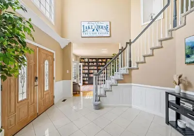 a large hallway with a staircase and a door at 13-Acre Private Estate, Private Lake, Private Golf Range, Private Forest & Hiking Trails in Ross Corner