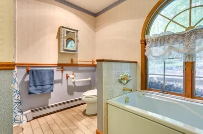 a bathroom with a tub and a toilet and a window at Sparrow Bush Retreat with Pool and Screened Porch in Sparrow Bush