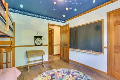 a room with a large screen on the wall at Sparrow Bush Retreat with Pool and Screened Porch in Sparrow Bush