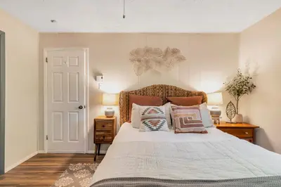 a bedroom with a bed with pillows on it at 3 bedroom Rental pet friendly, fireplace, hot tub, near ski resorts in Albrightsville