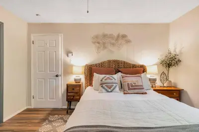 a bedroom with a large bed with pillows on it at 3 bedroom Rental pet friendly, fireplace, hot tub, near ski resorts in Albrightsville
