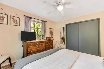 a bedroom with a bed and a flat screen tv at 3 bedroom Rental pet friendly, fireplace, hot tub, near ski resorts in Albrightsville