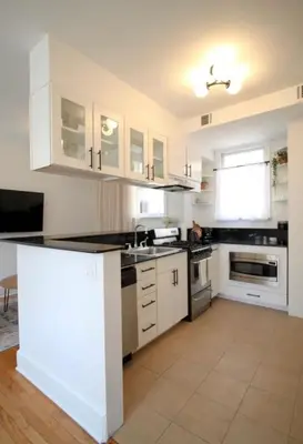 a kitchen with white cabinets and a counter top at StayRafa At 253 3F in Philadelphia