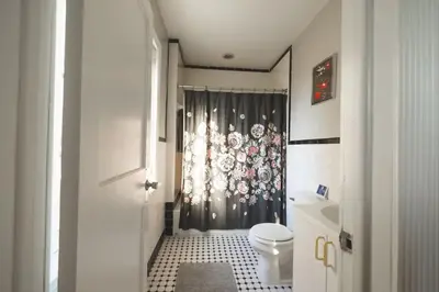 a bathroom with a shower curtain and a toilet at StayRafa At 253 3F in Philadelphia