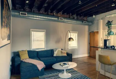 a living room with a blue couch and a table at StayRafa At 253 3F in Philadelphia