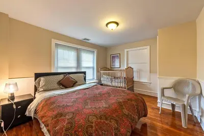 a bedroom with a bed and a crib in it at 5 Bdrm House (Sleeps 10) Horsham-Philadelphia in Horsham