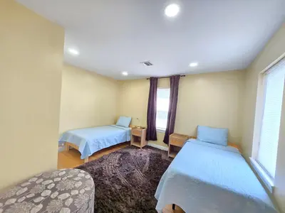 a bedroom with two beds and a window at Large Group Home NJ Close To NYC Train in Boonton