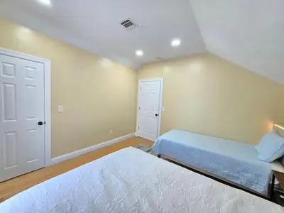 a bedroom with two beds and a closet at Large Group Home NJ Close To NYC Train in Boonton