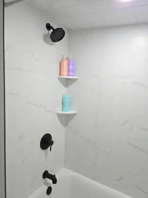 a bathroom with a shower with two shelves at Large Group Home NJ Close To NYC Train in Boonton