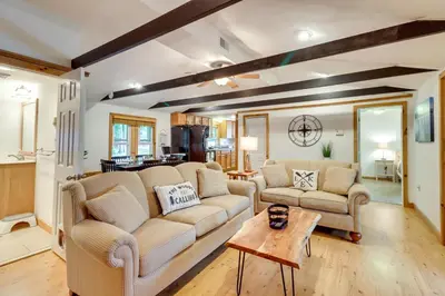 a living room with two couches and a table at Walk to Beaches Tree-Lined Pocono Lake Retreat! in Pocono Lake