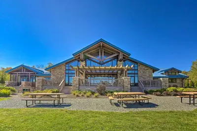 a building with picnic tables in front of it at Walk to Beaches Tree-Lined Pocono Lake Retreat! in Pocono Lake