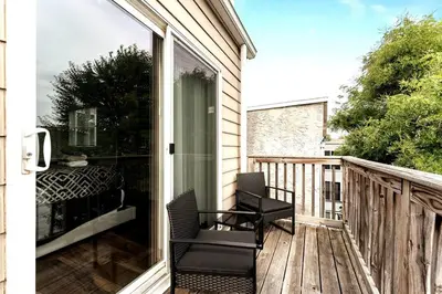 a balcony with a chair and a sliding glass door at Hidden Gem in Philadelphia