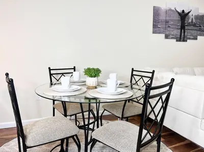 a dining room table with four chairs and a couch at Hidden Gem in Philadelphia