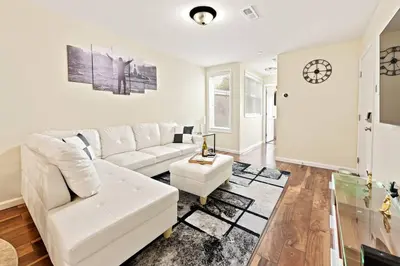 a living room with a white couch and a table at Hidden Gem in Philadelphia
