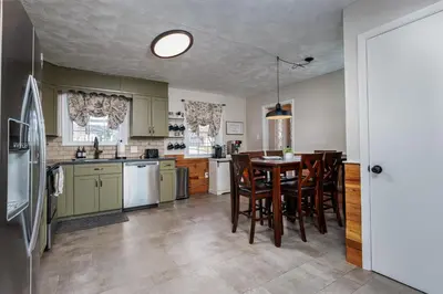 a kitchen with a table and chairs in it at The Craftsman's Homestay in Gordonville