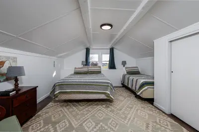 a bedroom with two beds and a window at The Craftsman's Homestay in Gordonville