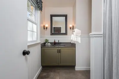a bathroom with a sink and a mirror at The Craftsman's Homestay in Gordonville