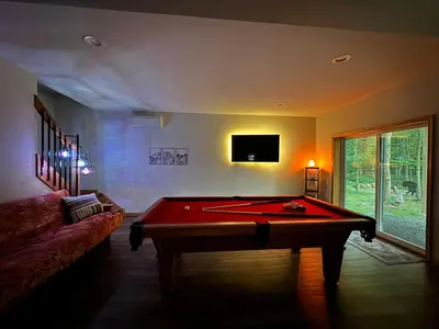 a living room with a pool table and a tv at Evergreen Escape - Jim Thorpe Multi Ski Resort in Albrightsville