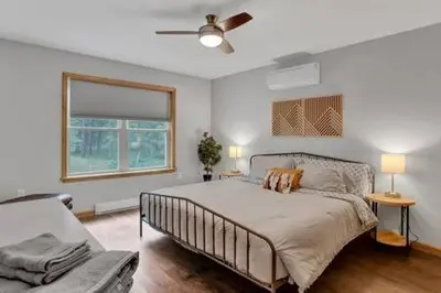 a bedroom with a bed and a window and a couch at Evergreen Escape - Jim Thorpe Multi Ski Resort in Albrightsville