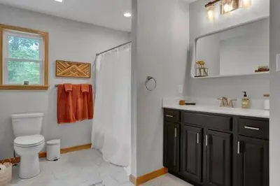 a bathroom with a sink and a toilet and a mirror at Evergreen Escape - Jim Thorpe Multi Ski Resort in Albrightsville