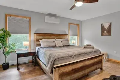 a bedroom with a large bed and a window at Evergreen Escape - Jim Thorpe Multi Ski Resort in Albrightsville