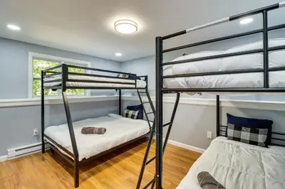 two bunk beds in a bedroom with blue walls at On-Site Lakes and Pools Inviting Tobyhanna Home! in Tobyhanna