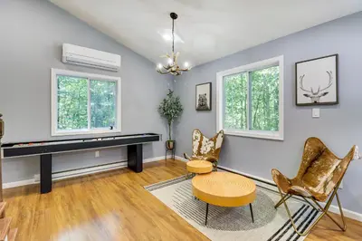 a living room with a piano and chairs at On-Site Lakes and Pools Inviting Tobyhanna Home! in Tobyhanna