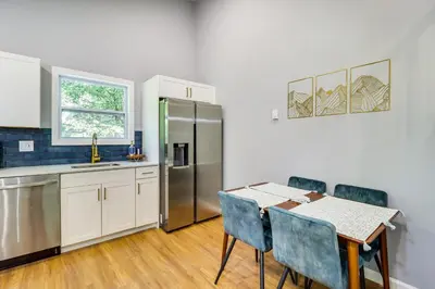 a kitchen with a table and a refrigerator at On-Site Lakes and Pools Inviting Tobyhanna Home! in Tobyhanna