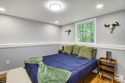 a bedroom with a purple bed and a window at On-Site Lakes and Pools Inviting Tobyhanna Home! in Tobyhanna