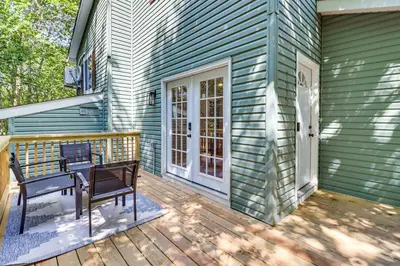 a wooden deck with a bench on a house at On-Site Lakes and Pools Inviting Tobyhanna Home! in Tobyhanna