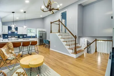a kitchen and living room with a staircase in a house at On-Site Lakes and Pools Inviting Tobyhanna Home! in Tobyhanna