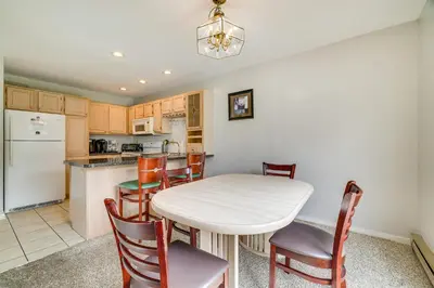 a kitchen and dining room with a table and chairs at Near Big Boulder Mtn! Home with Fireplace and Games in Lake Harmony