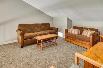 a living room with a couch and a table at Near Big Boulder Mtn! Home with Fireplace and Games in Lake Harmony
