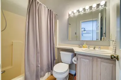 a bathroom with a toilet and a sink and a mirror at Near Big Boulder Mtn! Home with Fireplace and Games in Lake Harmony