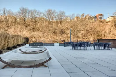 a patio with tables and chairs and a fence at Hoboken 2BR w Doorman Gym WD nr shuttle NYC-717 in Hoboken