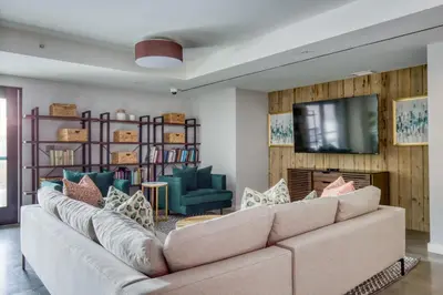 a living room with a couch and a television at Hoboken 2BR w Doorman Gym WD nr shuttle NYC-717 in Hoboken