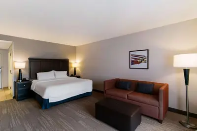 a hotel room with a bed and a couch at Hampton Inn & Suites Wilmington Christiana in Newark
