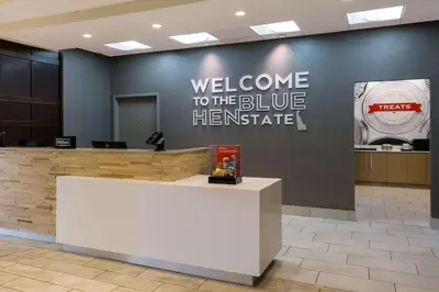 a welcome to the blue hermitage sign on a wall in a lobby at Hampton Inn & Suites Wilmington Christiana in Newark
