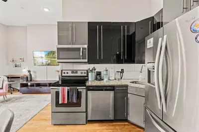 a kitchen with stainless steel appliances and a refrigerator at Beautiful 1BD With Balcony Hosted By StayRafa - 2F in Philadelphia