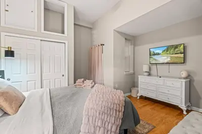 a bedroom with a bed with a dresser and a tv at Beautiful 1BD With Balcony Hosted By StayRafa - 2F in Philadelphia