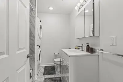 a white bathroom with a toilet and a sink at Beautiful 1BD With Balcony Hosted By StayRafa - 2F in Philadelphia
