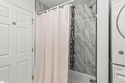a shower with a white shower curtain in a bathroom at Beautiful 1BD With Balcony Hosted By StayRafa - 2F in Philadelphia